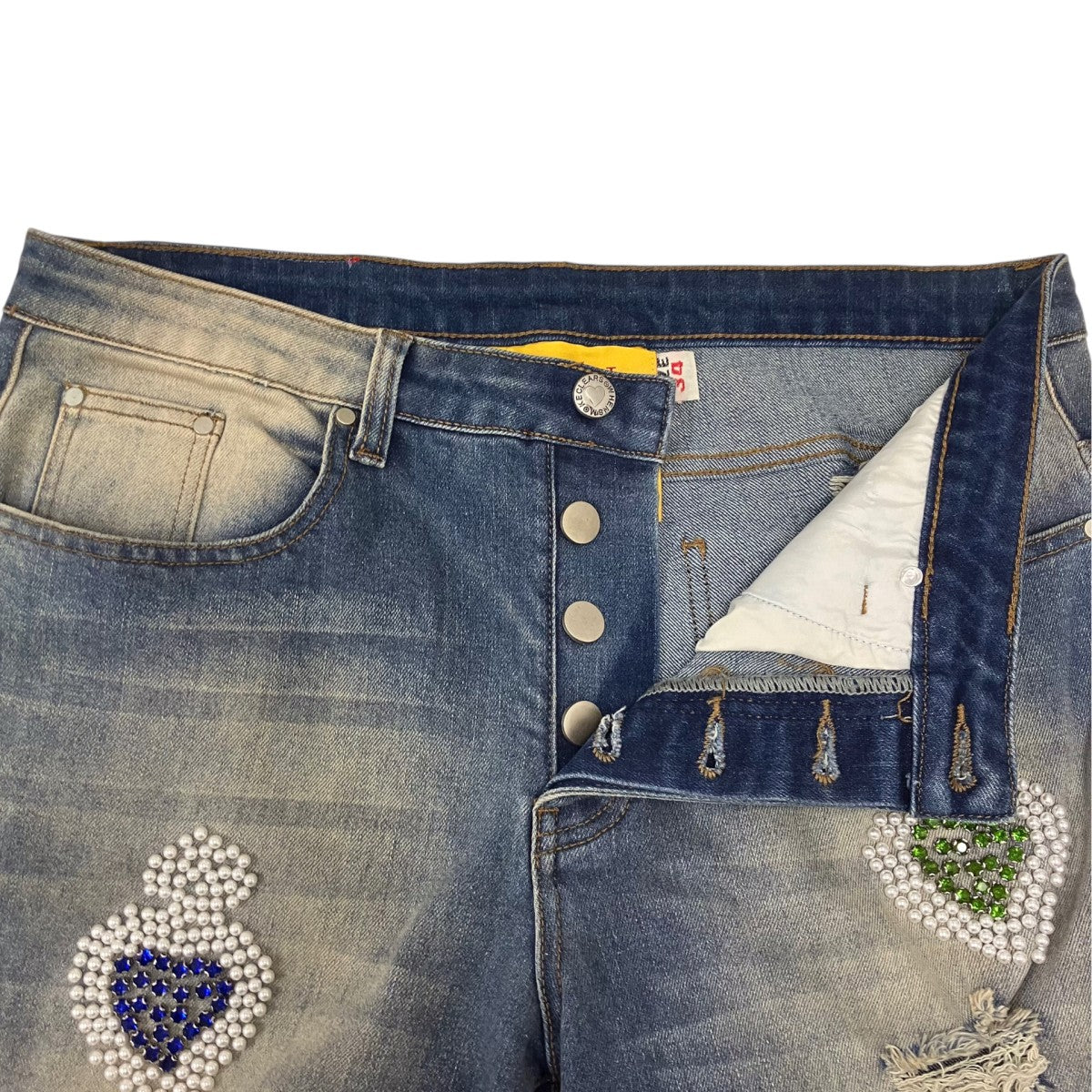 DISTRESSED NAILHEAD JEANS デニムパンツ